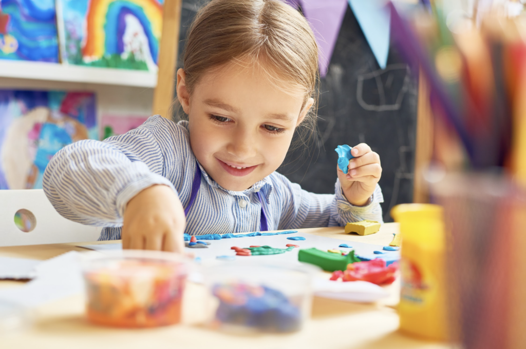 Young girl practicing a grasp activity to build fine motor skills